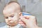 Cute adorable baby eating porridge with a spoonful of the concept of proper nutrition