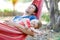 Cute adorable baby girl of 6 months and her father sleeping peaceful in hammock in outdoor garden