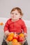 Cute adorable Caucasian baby boy eating citrus fruit. Finny child eating healthy organic seasonal summer snack meal. Solid finger