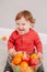 Cute adorable Caucasian baby boy eating citrus fruit. Finny child eating healthy organic snack. Solid finger supplementary food