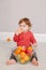 Cute adorable Caucasian baby boy eating citrus fruit. Finny child eating healthy organic snack. Solid finger supplementary food