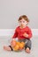 Cute adorable Caucasian baby boy eating citrus fruit. Finny child eating healthy organic snack. Solid finger supplementary food