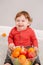 Cute adorable Caucasian baby boy eating citrus fruits. Finny child eating healthy organic snack. Solid finger food and