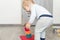 Cute adorable caucasian baby boy playing colorful toys at home. Happy child having fun building tower of soft rubber cubes.