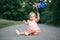 Cute adorable Caucasian baby girl waving Australian flag. Smiling child sitting on street road in park celebrating Australia Day