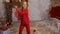 Cute adorable caucasian blond little girl in red vintage retro suit enjoy having fun dancing at christmas or new year