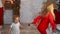 Cute adorable caucasian blond little girl in red vintage retro suit enjoy having fun dancing at christmas or new year