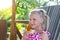 Cute adorable caucasian blond little kid girl enjoy having fun relaxing and eat mango fruit popsicle icecream sitting on