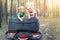 Cute adorable caucasian blond siblings having fun during atv 4x4 off-road adventure trip amog coniferous pine forest on brigh