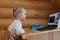 Cute adorable caucasian little blond girl siiting at desk with laptopn during online video chat scholl lesson session with teacher