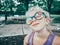 cute adorable Caucasian pretty little preschooler blonde girl wearing funny holographic colored sunglasses