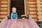 Cute adorable caucasian toddler boy having fun sliding down wooden slide at eco-friendly natural playground at backyard in autumn