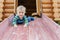 Cute adorable caucasian toddler boy having fun sliding down wooden slide at eco-friendly natural playground at backyard in autumn