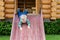 Cute adorable caucasian toddler boy having fun sliding down wooden slide at eco-friendly natural playground at backyard in autumn