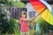 Cute adorable child, boy, playing with colorful umbrella under s