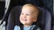 Cute adorable happy caucasian blond toddler boy sitting in stroller and laughing playing seek and hide game. Funny