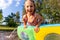 Cute adorable playful caucasian blond kid girl enjoy having fun swimming and splashing in small inflatable pool at house