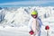 Cute adorable preschooler caucasian kid girl portrait with ski in helmet, goggles and unicorn fun costume enjoy winter sport