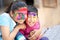 Cute adorable siblings playing with colours during holi festival of colors Indian asian caucasian creative portrait