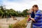 Cute adorable toddler girl and father watching and feeding giraffe in zoo. Happy baby child, daughter and dad, family