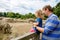 Cute adorable toddler girl and father watching wild rhinos in zoo. Happy baby child, daughter and dad, family having fun