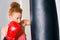 Cute adult boxer using punching bag