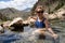 Cute adult woman wearing an American flag swimsut soaks and enjoys the Goldbug Hot Springs in the Salmon Challis National Forest