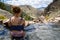 Cute adult woman wearing an American flag swimsut soaks and enjoys the Goldbug Hot Springs in the Salmon Challis National Forest