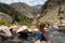 Cute adult woman wearing an American flag swimsut soaks and enjoys the Goldbug Hot Springs in the Salmon Challis National Forest
