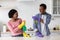 Cute african american couple shooting with cleaning sprays