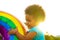 cute african american little girl with curly afro hair playing rainbow balloon outdoors