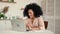 Cute african american woman focused thinking, typing on laptop, happy to have a good idea. Black female posing sitting