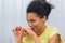 Cute African American woman talking by video call on a laptop. A young woman demonstrates a Easter painted egg while