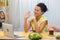 Cute African American woman talking by video call on a laptop. A young woman demonstrates a painted egg and Easter cake