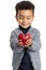 Cute afro american boy holding red heart in hands.