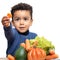 Cute afro american boy showing piece of vegetable at table