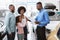 Cute Afro girl high fiving positive salesman at car dealership