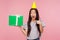 Cute amazed girl with party cone on head pointing at gift box and looking with amazement