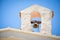 Cute ancient small bell tower with a bell upon a country church in a beautiful sunny day.