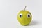 Cute Apple with funny face on white background. Green Apple with Googly eyes