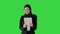 Cute Arabian businesswoman using tablet computer while walking on a Green Screen, Chroma Key.