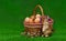 Cute artificial easter bunny sitting on grass near eggs, basket and pussy-willow twigs on a green background