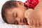 Cute asian baby in chinese traditional red dress sleeping