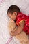 Cute asian baby in chinese traditional red dress sleeping