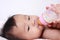 Cute Asian Baby Girl Bottle Feeding