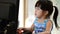 Cute asian baby girl playing computer