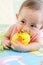 Cute Asian baby girl playing with robber duck toy