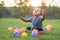 Cute asian baby playing colorful ball in green grass