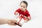 Cute asian baby in red bodysuit get gift box sitting on white blanket at home.Give Year present to child,kid,toddler.Concept