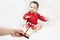 Cute asian baby in red bodysuit get gift box sitting on white blanket at home.Give Year present to child,kid,toddler.Concept